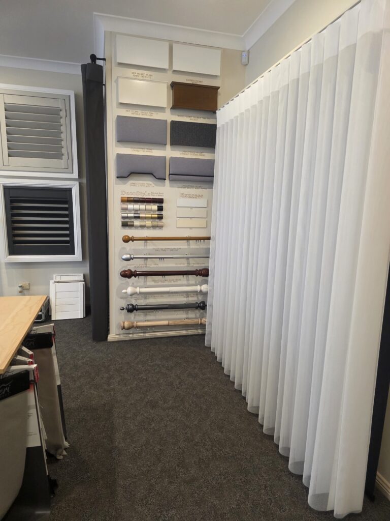 Sheer curtains, plantation shutter and curtain rod displays in the Campbelltown showroom