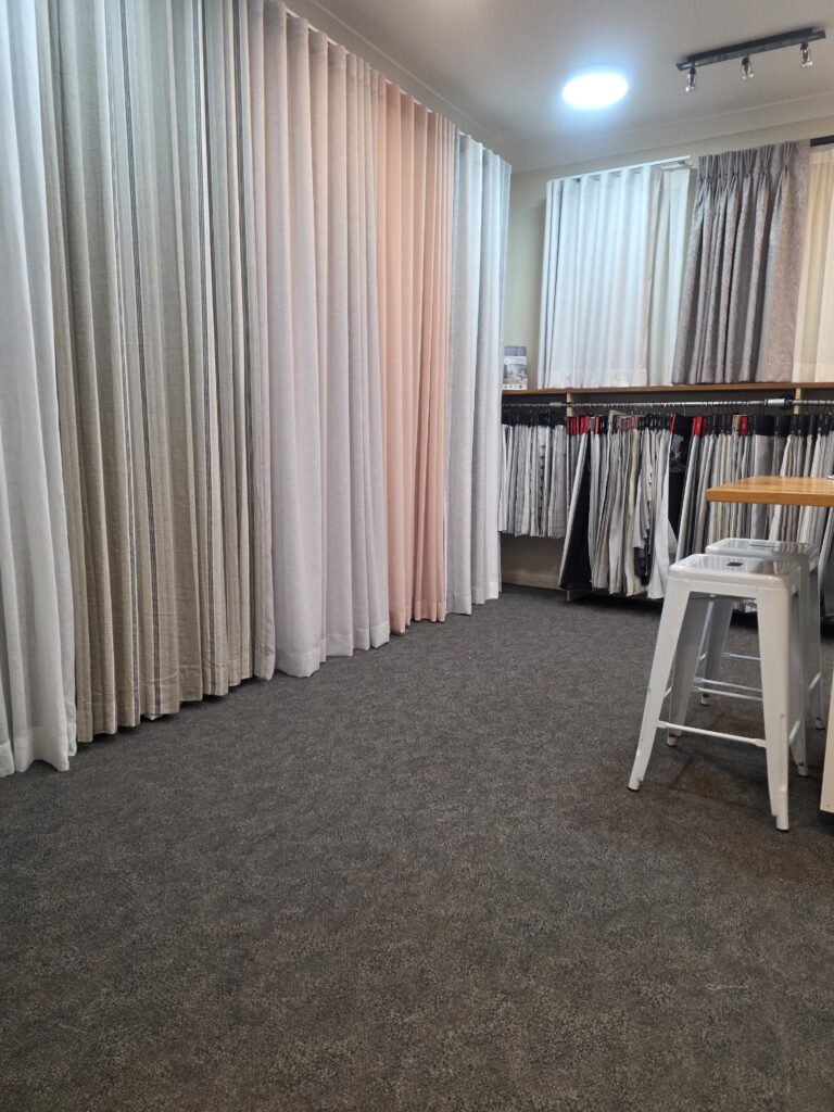 Curtain displays and fabric sample racks in the Cobb & Co Blinds showroom