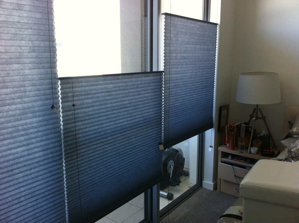 Blue top-down bottom-up honeycomb blinds in a bedroom