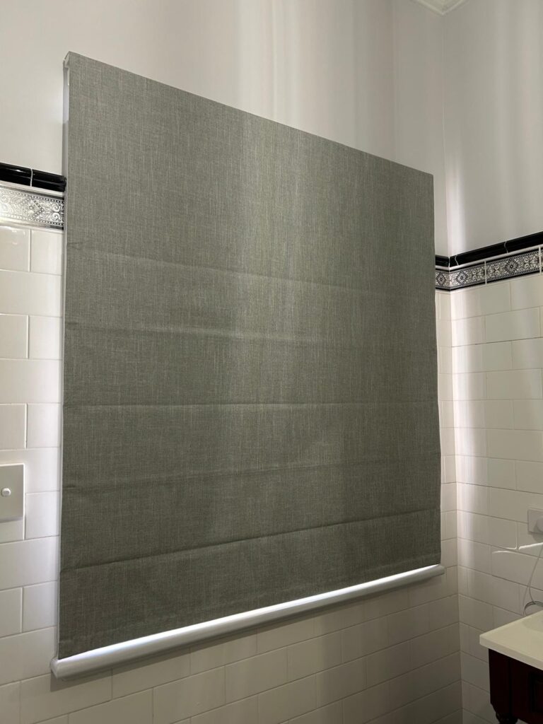 Grey Roman blind in a bathroom