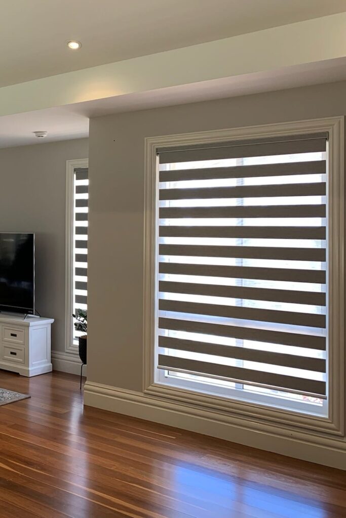 Grey zebra blind on a tall living room window